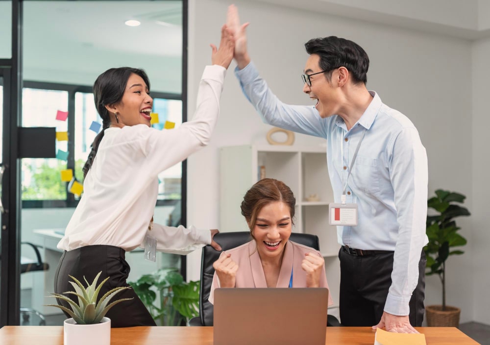 Two colleagues in a meeting, one taking credit for the work done by the other, illustrating self-serving bias in the workplace.