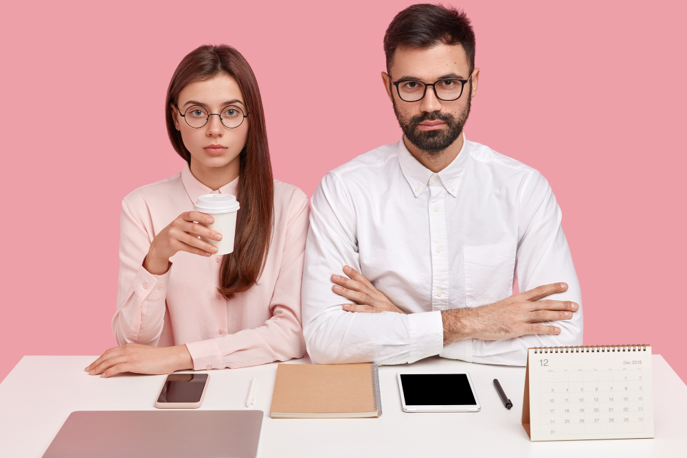 serious male and female showing perfectionism in the workplace